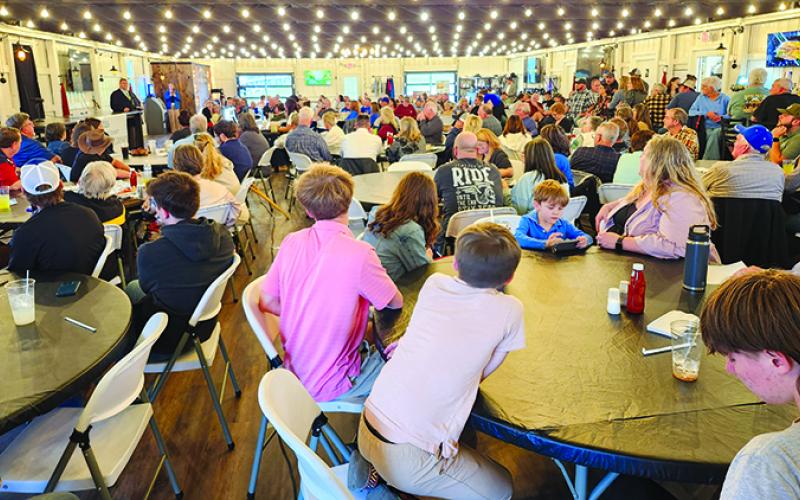 More than 200 people filled the clubhouse to meet the candidates and listen to the debate.
