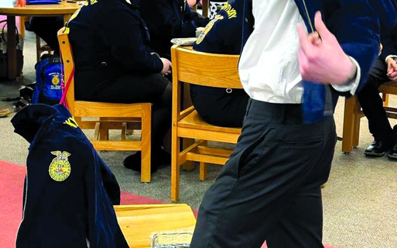 At Northern Kentucky FFA Regional Paperwork Day, March 24, Klaber Wolfe switches jackets upon retiring from his position as regional treasurer.