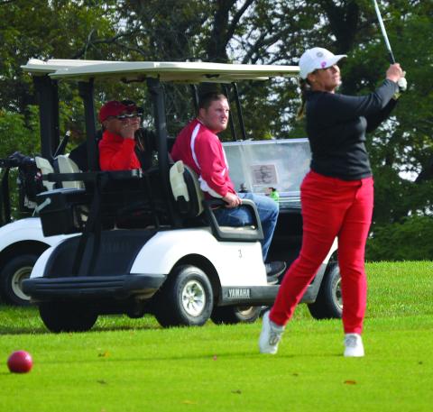  Emilie Bertram with a drive on #11 with Coach Rob Bertram, mom Jodi and AD Jordan Woodruff watching. Photos by Keith Smith