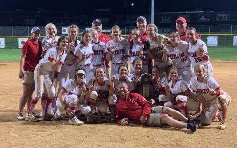 Ladycats Fast Pitch recreate their regional team championship photo with Superintendent Joe Buerkley