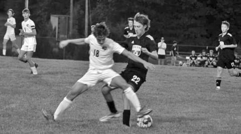 Jonathan Roenker makes a play on the ball challenging the Grant County attacker. Photo by Kacia Shipley