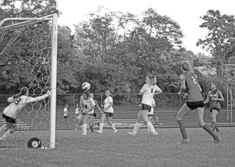 Eva Record moves on the backside of the goal towards the shot. Photo by Scott Collins