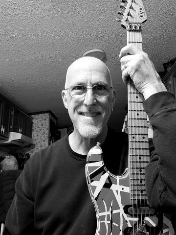 Tom Weber, guitar tech for Eddie Van Halen, shown with one of the guitars often used by Van Halen.