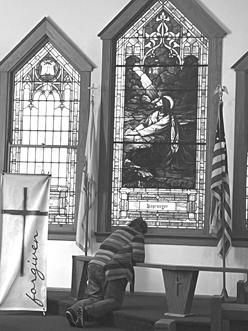 A parishioner bows in prayer during the prayer service at Butler Methodist. Photo by Brenda Higgins.