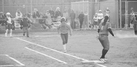 Logan Cooper attempts to bunt her way to first base. Photo by Sam McClanahan