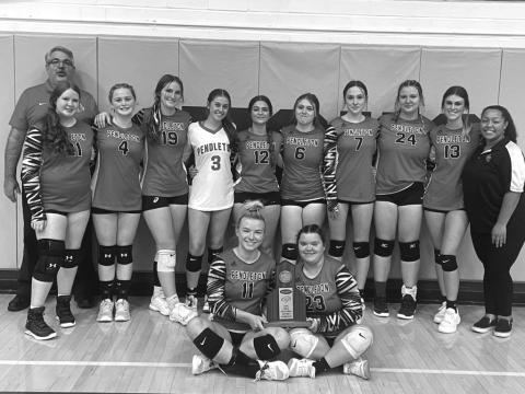 Ladycats pose with their District runner-up trophy. Photo courtesy of Sam McClanahan and Will Jones/10thregion.comy. Bottom Left: Allison Aulick serves up an ace for the Ladycats.
