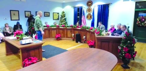 In the past two meetings, the mayor has stood over council rather than sitting with them in the center as is his usual place. This photo was taken as the council was voting to proceed with the budget amendment, hiring a lawyer, and to enter a closed session as is prescribed by law.