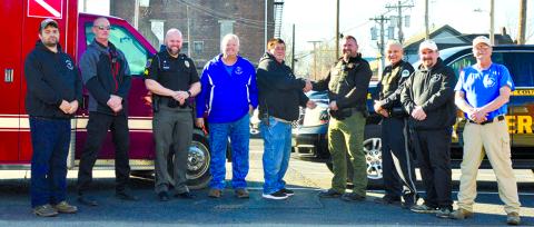 PC Search and Rescue met with the PC Sheriff, Butler Police and Falmouth Police Friday, December 15, to hand off the $2,700 they had collected in a fill-the-boot-type fundraiser for the Cops and Kids shopping event. Those present were Chris Lynch and Brian McCann of PCS&R, Brody Schmeng of Falmouth Police, Darrin Brown and Scotty McElfresh of PCS&R, Ken Hale of Butler Police, and Doug Smith and John Carson of PCS&R. Photo by Jessie Beckett.