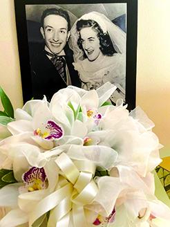 A bouquet of orchids sits in front of a photo from the Klees' wedding day on Jan. 15, 1949. Photo provided by Marianne Klee Roseberry.
