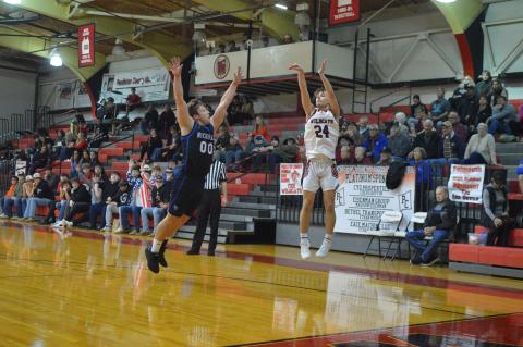 Wildcat junior Luke Gregg fires a three from the corner during the team's home game against Nicholas County on Feb. 12. Photo by Sam McClanahan.
