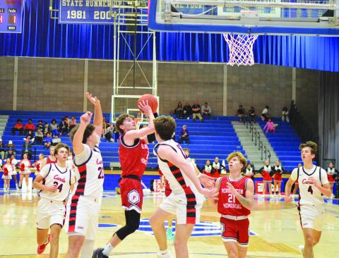Senior Alex Beyst puts up a jumper during the fourth quarter. All photos by Sam McClanahan.