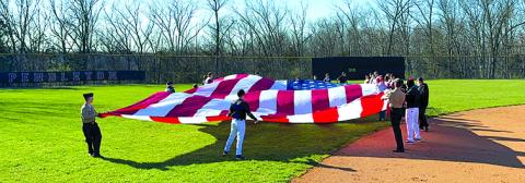 30 foot by 50 foot United States flag unfurled and steady during the playing of “The Star-Spangled Banner”