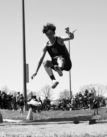 Wildcat Jamison Tucker goes airborne during his first place performance in the long jump competition. Photo courtesy of Beverly Beckett.