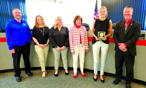 Congratulating Pendleton County High School senior Ava Record for her term on the Board of Education are, from left, board members Derek Brown, Laura Schack, Amber Bebe and Cheryl Griffin; Record; and district Superintendent Joe Buerkley. Photo by Burton Cole.  
