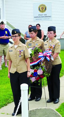 Pendleton County High School Navy Junior Reserve Officers Training Corps cadets, from left, Sierra Deatherage, Catalina Furman and Georgia Oliver prepare to place a wreath in honor of fallen military personnel during Memorial Day ceremonies May 26 outside the Hardin Browning American Legion Post 109 in Falmouth. A severe storm that moved in that afternoon shortened the outdoor services, and the rest of the program, including the keynote address by Evan Meyer, pastor of Antioch Mills Christian Church, was mo