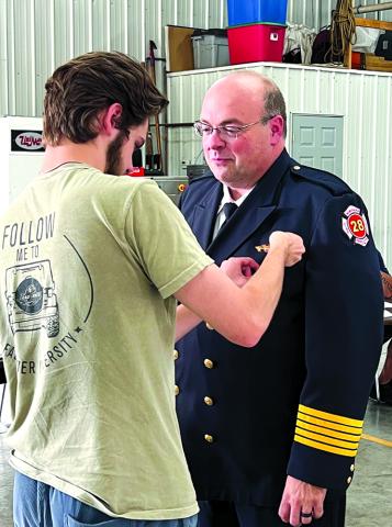 NPFD Chief Adam Fuller receives his Chief's badge.