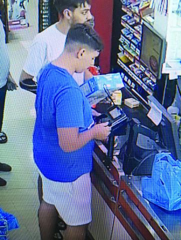 Surveillance video of man installing skimmer device