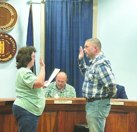 Newly appointed Assistant Fire Chief Jared Brown takes the oath of office.