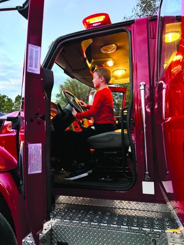 Youngsters get to experience the inside of emergency vehicles.