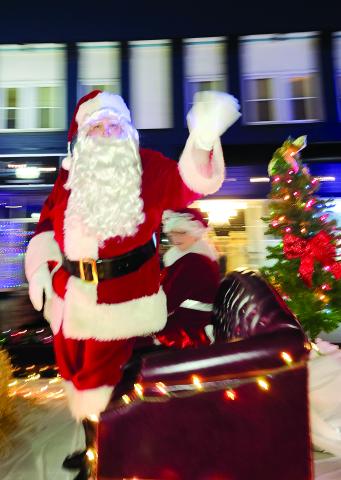 Special guest Santa Claus waves to the crowds lining Shelby Street in downtown Falmouth Saturday during the annual Christmas parade. Photo by Burton Cole.