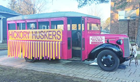 Outside of the entrance to the Hoosier Gym, a 1939 Chevrolet bus used in the 1986 basketball movie Hoosiers which includes a cutout photo of the film's star, Gene Hackman. Photos by: Sam McClanahan, Layne Nelson, and Justin Reckner.