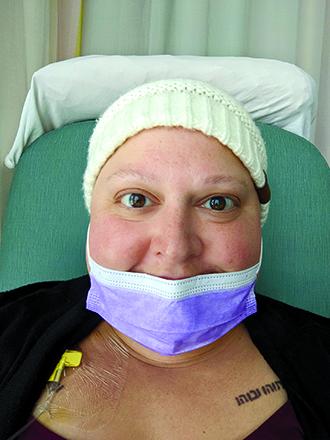 Miranda Geers of the Falmouth area smiles while undergoing a chemotherapy treatment. Geers was 41 — more than 20 years younger than normal — when diagnosed with ovarian cancer Feb. 13, 2021.