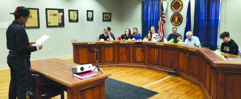 Pendleton County High School student Gavin Laney, left, portraying John “No More Tax Breaks” Benedict, states his case before “Kennett City Council” about why he opposes tax incentives to bring new business Plastics R Us into the city. The session Thursday in Falmouth City Council chambers was part of a Pendleton County Youth Leadership Economic Development Simulation that paired gifted students with mentors from Falmouth, the county and the state to develop more of an understanding of the process involved 