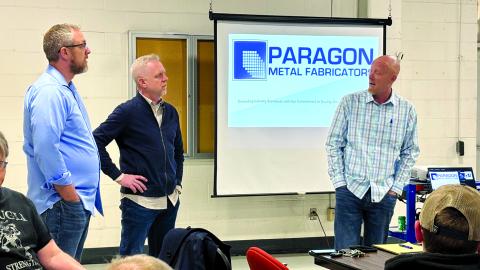 Brothers Matthew, left, Jason and Bryan Muehlenkamp, owners of Paragon Metal Fabricators in Erlanger, meet Friday morning with employees of the closed Hammer Strength factory in Falmouth to discuss expanding Paragon into the Hammer Strength building and the job opportunities the move will create. Photo by Tami Vater.
