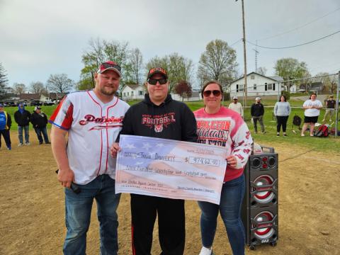 Travis Daugherty, center, shown with brother and Patriot baseball director Marty Daugherty, and friend Megan Smith, right. Monies raised from the tournament were given to support the Daugherty family.