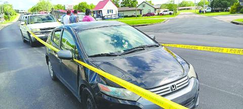 Bullet holes are seen in the windshield and hood of this sedan after a shootout Saturday between the occupants of two vehicles. Ethan Groneck, 18, of Alexandria, is in custody, and Adam Duncan, 20, originally of Pendleton County remains at large after the gunplay that followed an argument, police said. No one was injured. Photo by Sam McClanahan.