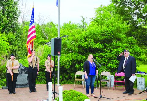 Callie Daugherty sings “The Star-Spangled Banner” during the Memorial Day ceremony May 25 the Hardin Browning American Legion Post 109 in Falmouth. Colors are presented by Pendleton County High School Navy Junior Reserve Officer Training Corps cadets Lona Albos, left, Tanner Morris and Georgia Oliver. At right is Post Commander James Sharp.
