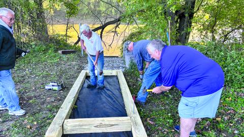 Getting the forms in place are, from left, Patrick Clore, Barth Johnson, Jerry Miller and Darryl Ammerman.