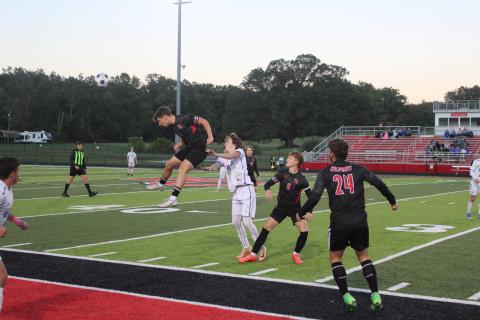 Wildcat senior Dawson Nichols goes airborne for a header during the teams district title game loss to Mason County on October 9. Photo by Sam McClanahan