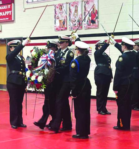 Pendleton County High School’s Navy Junior Reserve Officers Training Corps perform a wreath-laying ceremony, paying tribute to veterans past and present, during a dinner the school district put on on Veterans Day last week for the servicemen and women of the community.