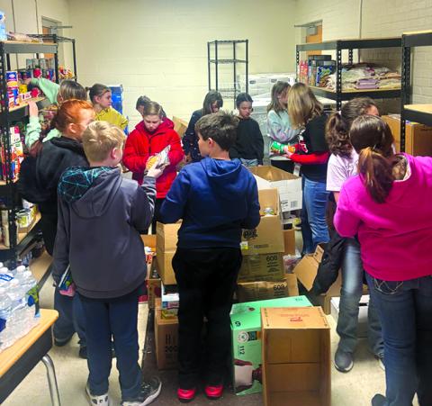 Students from Northern and Southern elementary schools stock the shelves at FRYSC.