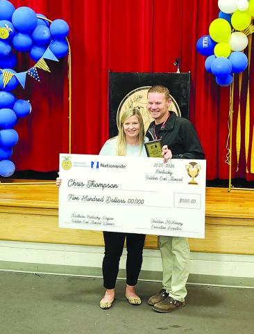 Pendleton County High School agriculture teachers Jaimie Mann, left, and Chris Thompson celebrate Thompson’s FFA Golden Owl Award for the Northern Kentucky Region. Photo by Burton Cole.