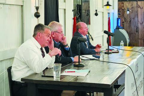 James Poynter, left, and Anthony Strong listen as Rick Mineer answers a question during a debate between candidates for Pendleton County Judge Executive March 25 at Pendleton Hills country club in Butler. The three, along with Sebastian Ernst, are vying to replace Pendleton County Judge Executive David Fields, who is retiring when his term expires at the end of the year.