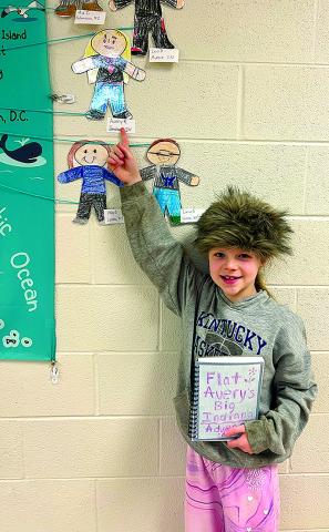 Second-grader Avery Roberts points to her character next to a map showing from where the classes’ Flat Stanley letters were sent.