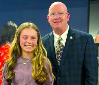 Pendleton County Soil Conservation District countywide writing contest winner Remmi Prince poses with Rep. Mark Hart. Not pictured are second place finisher Daniel Drury and third place finisher Ellie Fultz. 