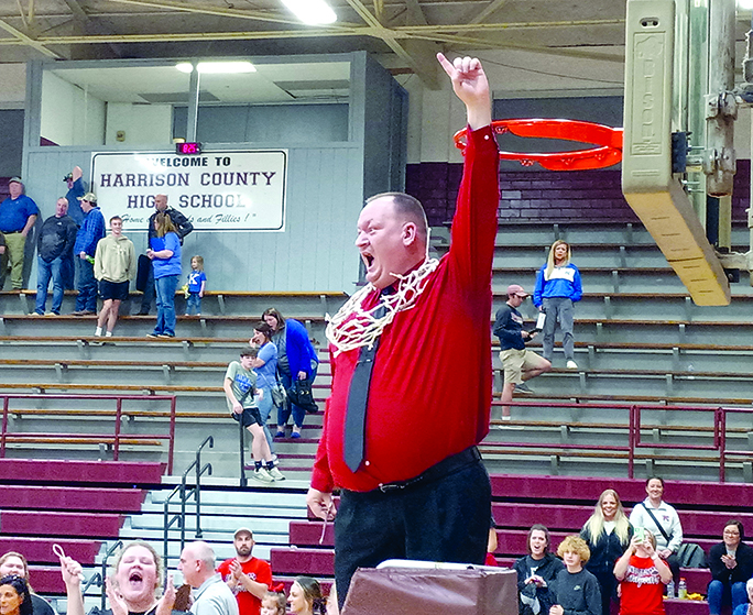 Patrick Kelsch returned to coaching this year after and made it count. Under his direction, the Ladycats won the most games the team has won in decades as well as the district title. He celebrates the big win after beating Nicholas County, taking first in the district. Photo by Stacey Myers.
