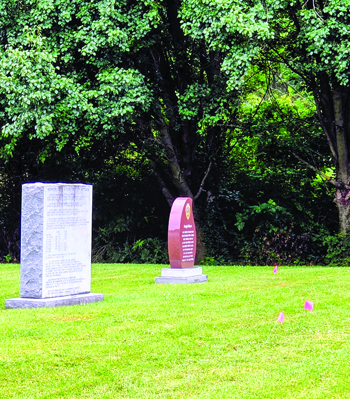 Pink flags mark where the ground-penetrating radar device detected unmarked graves at the Hardin-Browning American Legion Post 109 property in Falmouth.