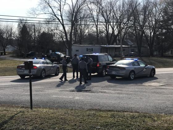 Multiple law enforcement agencies surround the trailer in Eastside Park