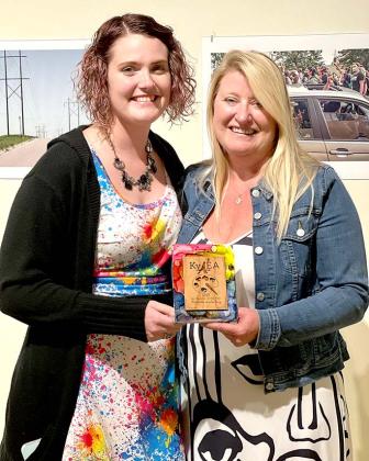 Former student Rachael King Burriss presents Michelle Lustenberg with the Kentucky Art Educator award at this year’s Kentucky Art Education Association’s  conference.
