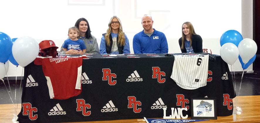 Kayley Bruener was joined by a slew of family, friends, and supporters of the PC Ladycats Fast-pitch Softball Program as she officially signed with Lindsey Wilson Tuesday, January 10. Bruener signed surrounded by her mother Maria, with Brylee on her lap, dad Adam, and sister Taylor. Photo by Sam McClanahan.