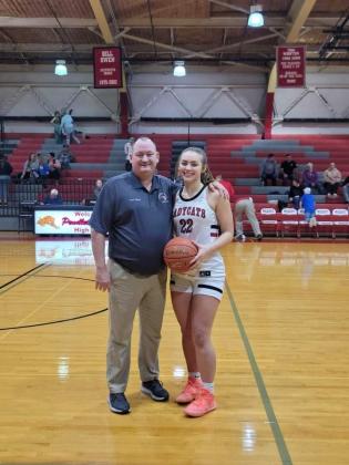 Ladycats senior Cara Stewart was honored before the start of the home game versus Lloyd on Jan. 6. She became the 10th girl in team history to reach 1,000 points for her career. She accomplished that feat in the Jan. 4 road game at Grant County. She’s pictured with team head coach Patrick Kelsch.