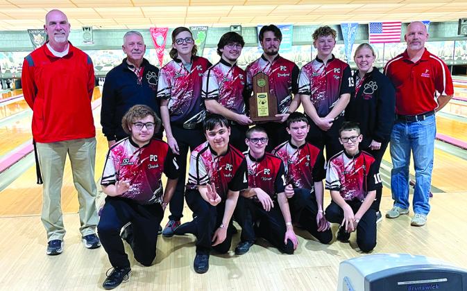 The Regional Champion Wildcats Bowling Team holds the trophy for their third Region 5 championship. The team is joined by Athletic Director Jon Wirth on the left and Principal Tony Dietrich on their right. 