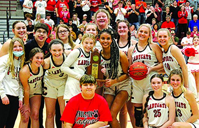 The Ladycats pose with the district trophy following their 21st win of the season. Photo by Stacey Myers.