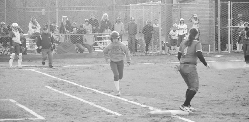 Logan Cooper attempts to bunt her way to first base. Photo by Sam McClanahan
