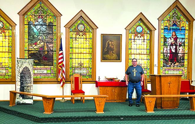 Minister Ron Schwarberg stands at the altar of Butler Christ Community Church. The church recently disaffiliated from the Methodist Council, and it is not alone. Methodist churches across the country took leave of the council by majority votes of the congregations after changes were made in procedure.