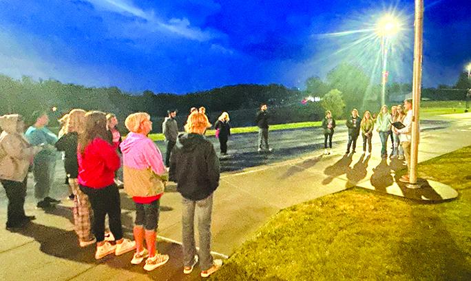 Students, faculty, and community members gather around the Pendleton County High School flagpole to worship and pray. Photo taken by Sheila Wright.